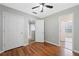 A bright bedroom with hardwood floors leads to other rooms through white doors at 174 Randall Dr, Rockmart, GA 30153