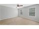 Spacious bedroom with neutral carpet, ceiling fan, and bright windows at 174 Randall Dr, Rockmart, GA 30153