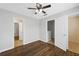 A bright bedroom with hardwood floors leads to other rooms through white doors at 174 Randall Dr, Rockmart, GA 30153