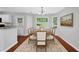 Dining room features a table with six chairs, large picture window, and flows into the kitchen at 174 Randall Dr, Rockmart, GA 30153