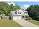 Beautiful two-story home featuring a manicured lawn, two-car garage, and inviting front porch at 174 Randall Dr, Rockmart, GA 30153