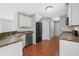 Bright kitchen with stainless steel appliances, white cabinets and hardwood floors at 174 Randall Dr, Rockmart, GA 30153