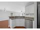 Modern kitchen features stainless steel appliances, a breakfast bar, and granite countertops at 174 Randall Dr, Rockmart, GA 30153