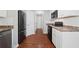 Well-lit kitchen with stainless steel appliances, white cabinets, and ample counter space at 174 Randall Dr, Rockmart, GA 30153