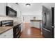 Modern kitchen featuring stainless steel appliances, white cabinets and hardwood flooring at 174 Randall Dr, Rockmart, GA 30153