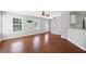 Bright living room with hardwood floors, large windows, and an open floor plan to kitchen at 174 Randall Dr, Rockmart, GA 30153