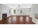 A bright living room showcasing a fireplace, hardwood floors, and large windows with great natural light at 174 Randall Dr, Rockmart, GA 30153