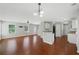 Spacious living room with hardwood floors, neutral paint, and open layout to the kitchen at 174 Randall Dr, Rockmart, GA 30153