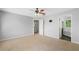 Carpeted main bedroom with a ceiling fan and adjoining primary bath at 174 Randall Dr, Rockmart, GA 30153