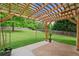Outdoor patio with wooden pergola, string lights, and manicured backyard perfect for entertaining guests at 174 Randall Dr, Rockmart, GA 30153