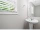 Bright powder room with pedestal sink and window allowing natural light at 174 Randall Dr, Rockmart, GA 30153