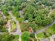 Aerial view of a neighborhood showcasing mature trees, and a private backyard pool at 3228 Turtle Lake Se Dr, Marietta, GA 30067