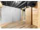 Basement features wood floors, exposed ceiling, and wood door at 3228 Turtle Lake Se Dr, Marietta, GA 30067