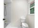 Bathtub with white tiles, a black shower head, and gold fixtures at 3228 Turtle Lake Se Dr, Marietta, GA 30067