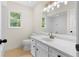 Well-lit bathroom with white tile, modern fixtures, and a vanity offering ample counter space and storage at 3228 Turtle Lake Se Dr, Marietta, GA 30067