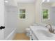 Bright bathroom featuring tile floors, a tub, and an updated vanity with a white countertop and a window at 3228 Turtle Lake Se Dr, Marietta, GA 30067