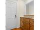 Hall bathroom with tile counter, rustic cabinets, and hardwood flooring at 3228 Turtle Lake Se Dr, Marietta, GA 30067