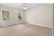 Bedroom featuring plush carpeting, two windows, and light-colored walls at 3228 Turtle Lake Se Dr, Marietta, GA 30067