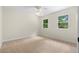 Bright bedroom featuring plush carpeting and light-filled windows overlooking a green yard at 3228 Turtle Lake Se Dr, Marietta, GA 30067