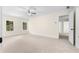 Bright bedroom featuring plush carpeting, a ceiling fan, and light-filled windows overlooking a lush yard at 3228 Turtle Lake Se Dr, Marietta, GA 30067