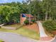 Charming two-story brick home featuring lush landscaping, blue shutters, and a long driveway at 3228 Turtle Lake Se Dr, Marietta, GA 30067