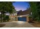 Charming two-story brick home with a dark blue front door and matching garage door at 3228 Turtle Lake Se Dr, Marietta, GA 30067