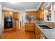 Kitchen featuring wood cabinets, granite countertops, stainless appliances and hardwood floors at 3228 Turtle Lake Se Dr, Marietta, GA 30067