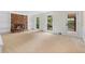 Open living room features a brick fireplace, built-in shelving and backyard access at 3228 Turtle Lake Se Dr, Marietta, GA 30067