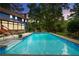 Enjoy this spacious swimming pool with tile accents, ladder, and lush landscaping at 3228 Turtle Lake Se Dr, Marietta, GA 30067