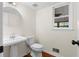Powder room featuring a pedestal sink, a toilet and hardwood floors at 3228 Turtle Lake Se Dr, Marietta, GA 30067