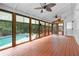 Relaxing sunroom with wood floors, ceiling fans, and views of the beautiful backyard pool at 3228 Turtle Lake Se Dr, Marietta, GA 30067