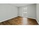 Bright bedroom with wood floors, neutral paint, and a large window offering natural light at 6851 Roswell Rd # H18, Atlanta, GA 30328