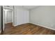 This bedroom features a closet with white doors and hardwood flooring at 6851 Roswell Rd # H18, Atlanta, GA 30328