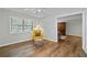 Bedroom shows wood floors, ceiling fan, window, chair seating and large decorative armoire at 6851 Roswell Rd # H18, Atlanta, GA 30328