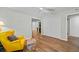 Bedroom shows wood floors, ceiling fan, window, seating and large closets for storage at 6851 Roswell Rd # H18, Atlanta, GA 30328