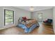 Charming bedroom with hardwood floors, large windows, and a decorative ceiling light at 6851 Roswell Rd # H18, Atlanta, GA 30328