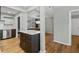 Modern kitchen features wood floors, light paint and an island with a white countertop at 6851 Roswell Rd # H18, Atlanta, GA 30328