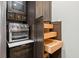 Gourmet kitchen showcasing wood cabinets, stainless steel appliances, and pull out shelving at 6851 Roswell Rd # H18, Atlanta, GA 30328