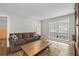 Living Room with wood floors, a large window, area rug, a couch, and a lamp at 6851 Roswell Rd # H18, Atlanta, GA 30328
