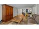 Bright open floor plan shows wood floors, dining room, kitchen and large decorative armoire at 6851 Roswell Rd # H18, Atlanta, GA 30328