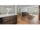 Bright living room features wood floors, area rug, sofa, and updated kitchen bar area at 6851 Roswell Rd # H18, Atlanta, GA 30328