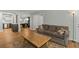 Spacious living room with wood floors, view of updated kitchen, dining area and sliding door at 6851 Roswell Rd # H18, Atlanta, GA 30328