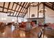 Grand lobby with high vaulted ceilings, exposed beams, stone fireplace, and hardwood floors at 6851 Roswell Rd # H18, Atlanta, GA 30328