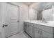 Bright bathroom featuring double vanity with white countertops and gray cabinets at 1825 Villageside Ct, Lawrenceville, GA 30043