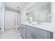 Bright bathroom with white countertops, gray cabinets, a large mirror, and a shower with a curtain at 1825 Villageside Ct, Lawrenceville, GA 30043