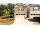 Charming two-story home with a two-car garage and well-manicured front yard at 1825 Villageside Ct, Lawrenceville, GA 30043