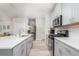 Modern kitchen featuring stainless steel appliances, light gray cabinets, and quartz countertops at 1825 Villageside Ct, Lawrenceville, GA 30043