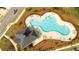 Aerial view of community pool, with lounge chairs and a unique shape at 1825 Villageside Ct, Lawrenceville, GA 30043
