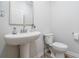Clean powder room with a pedestal sink and modern fixtures at 1825 Villageside Ct, Lawrenceville, GA 30043