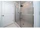 Tiled shower with glass door in a neutral-toned bathroom at 1825 Villageside Ct, Lawrenceville, GA 30043